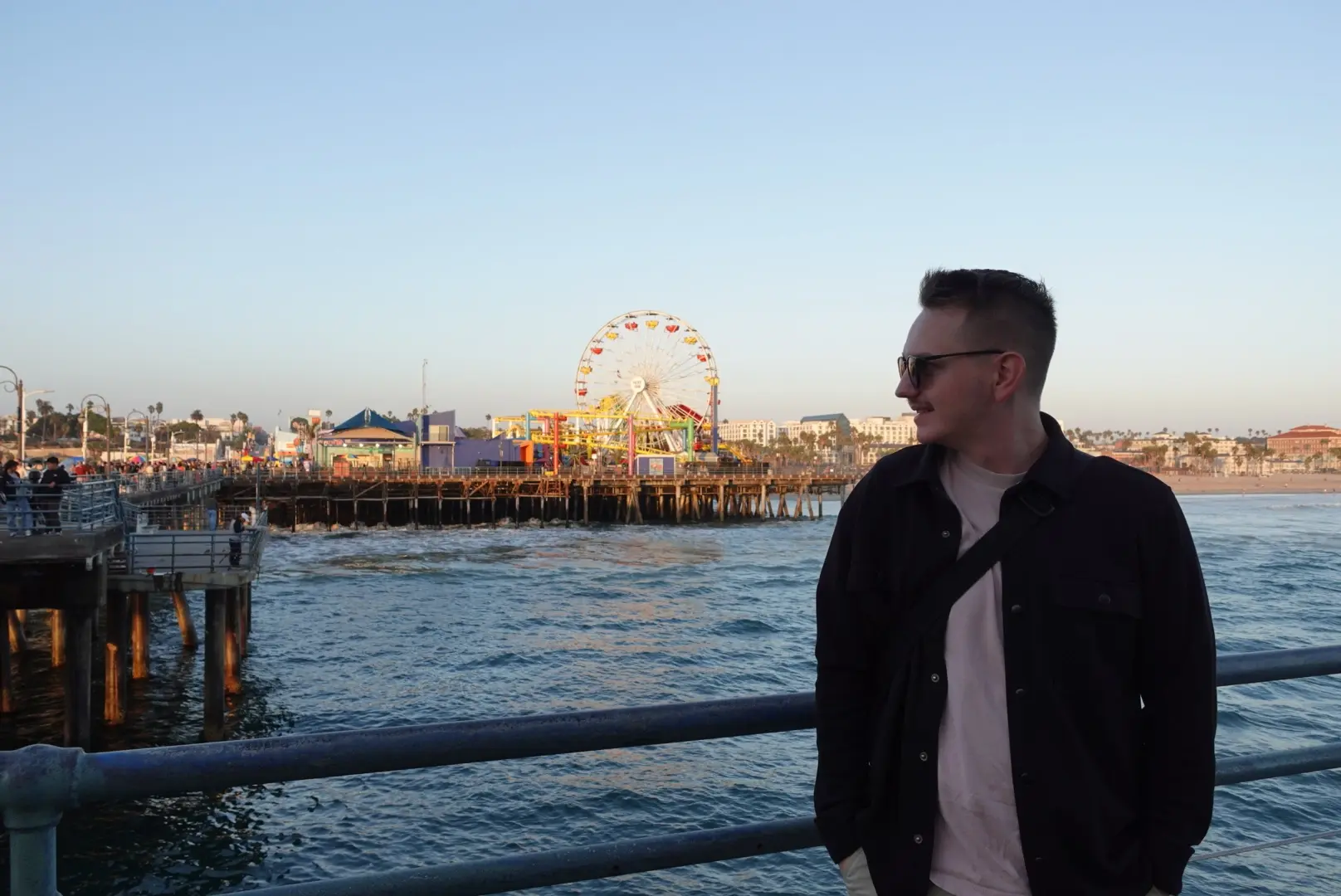 Dominik standing in front of the santa monica pier
